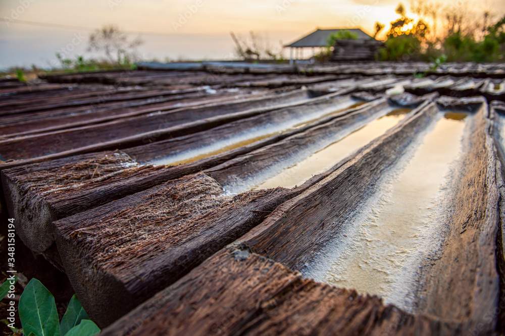 Ancient traditional salt production on the Bali island, Indonesia. Making sea salt Ancient traditional salt production on the Bali island, Indonesia. Making sea salt