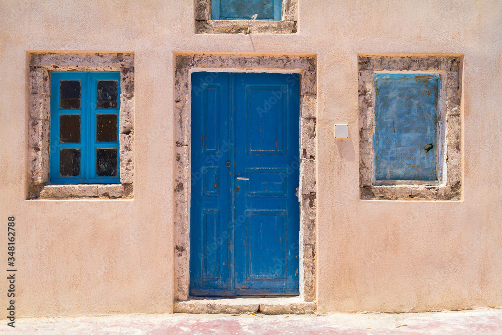 Architecture of Oia town with blue doors on Santorini island, Greece
