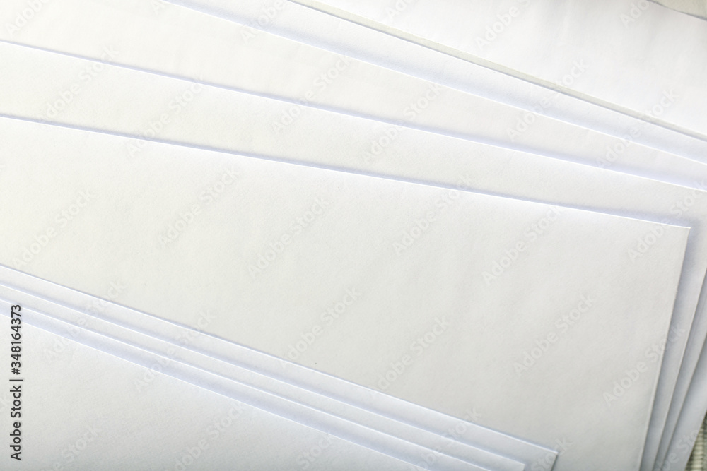 Obraz premium close up of stack of white letters or papers.
