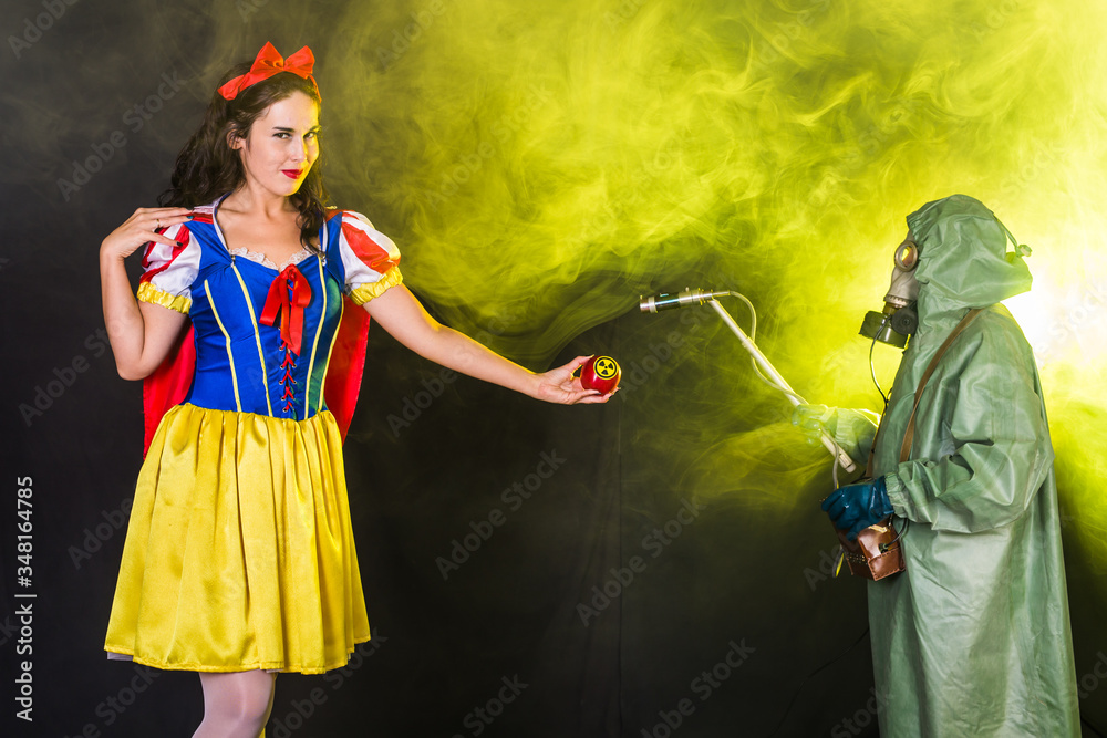 Fototapeta premium Woman holding hazardous radioactive apple. Nuclear and radiation measurement concept.