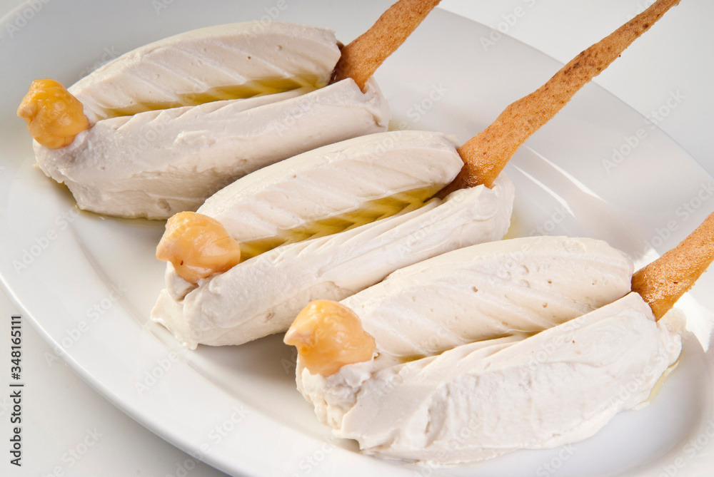 Bowl of hummus isolated on white background.
