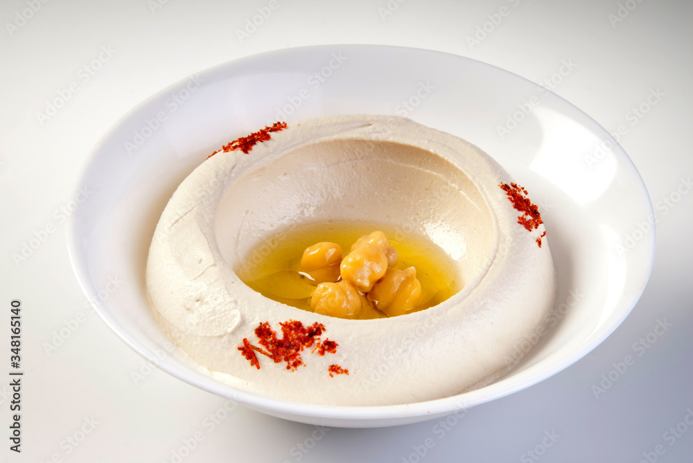 Bowl of hummus isolated on white background. Bowl of hummus isolated on white background.