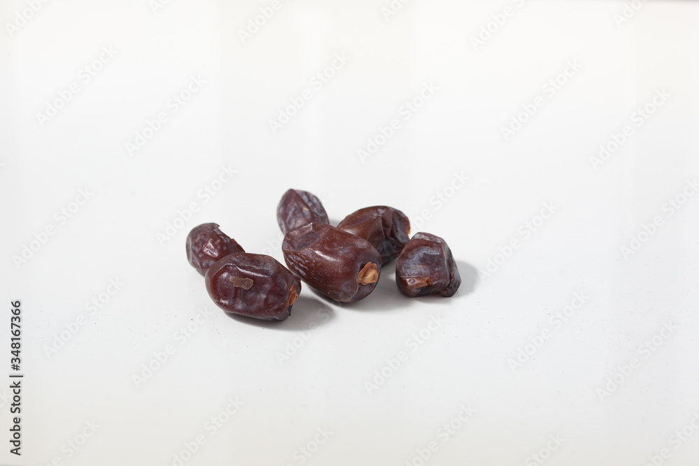 Obraz premium Dried dates fruits on white background, tasted sweet and chewy
