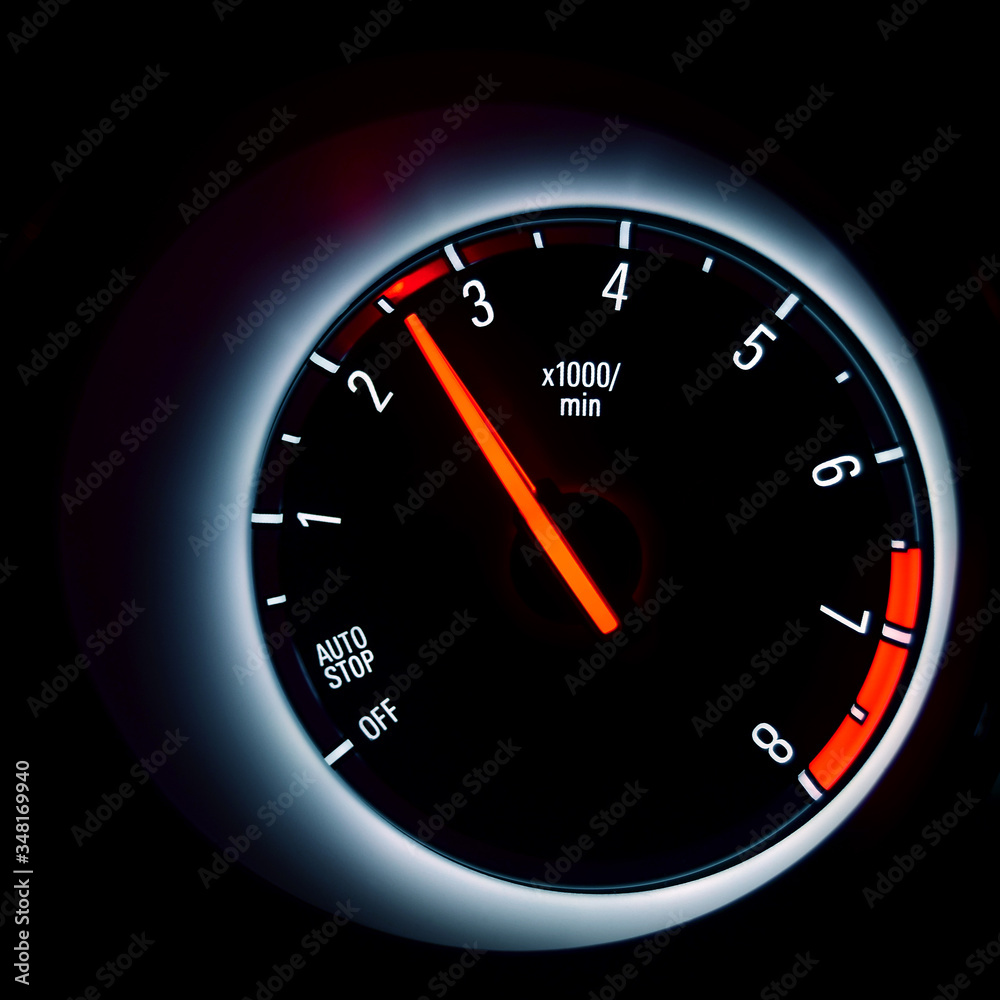 Car instrument cluster with tachometer showing engine idle speed Stock