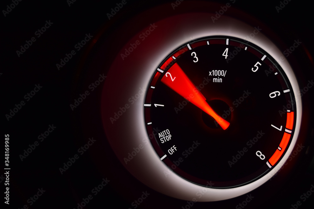 Car instrument cluster with tachometer showing engine idle speed