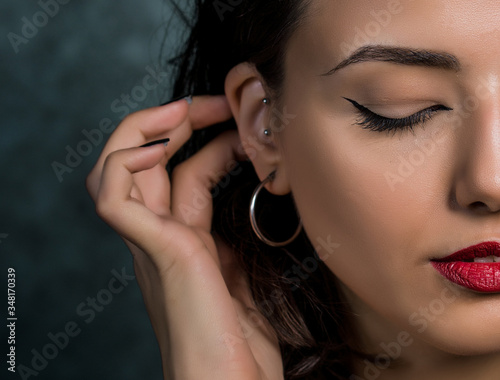 Close-up half face and body portrait of young beautiful woman
