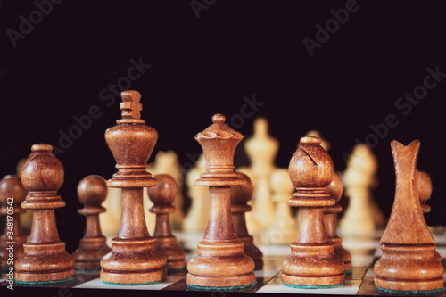 chess pieces on a table on a black background