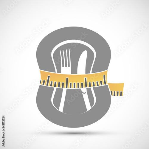 Measuring tailor tape around plate with knife and fork