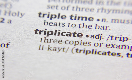 Triplicate word or phrase in a dictionary. photo