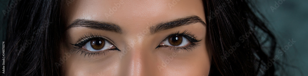 Obraz premium close-up photo of woman eye with eyeliner makeup on white background.