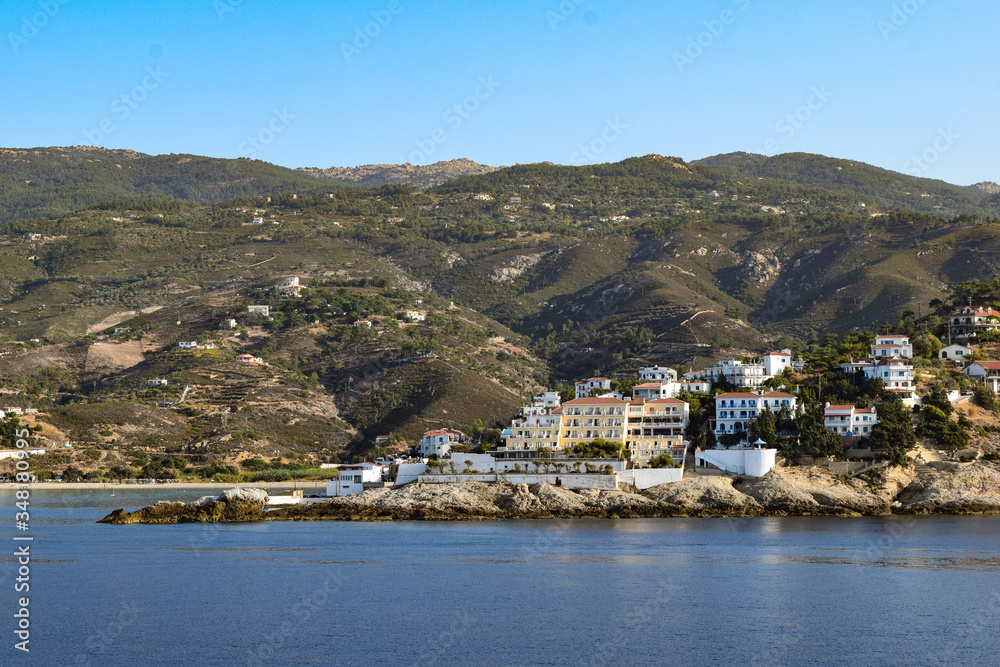 The town of Armenistis at Ikaria Island from a boat in a chill summer day