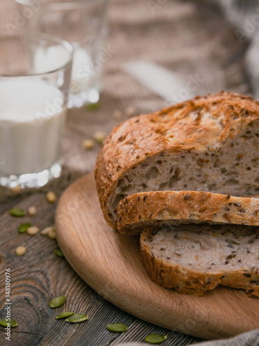 Bread and milk on planked wooden table. Vertical shot from above.