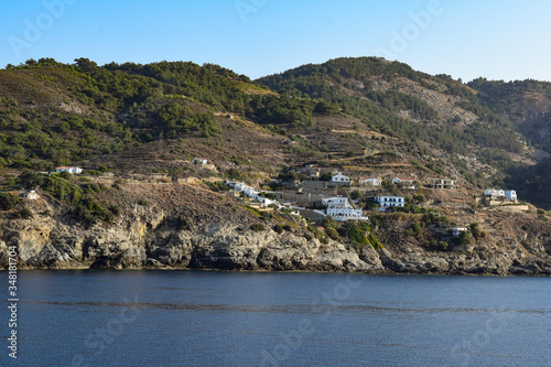 Ikaria island in the Greek Aegean Sea seen from the ferry boat Nisos Mykonos at a quiet sea day. Coastline of Ikaria