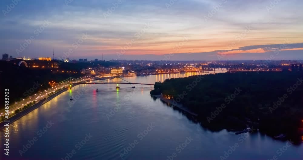 4K UHD Hyperlapse time-lapse of car traffic and people crossing road at night in in Kyiv. colorful led bridge across river and quay road 4K UHD Hyperlapse time-lapse of car traffic and people crossing road at night in in Kyiv. colorful led bridge across river and quay road