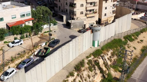 Security wall with Israeli idf watch tower Close to Shuafat Refugee Camp- Aerial
Crowded refugee camp, Israel, Jerusalem- May/10,2020
 photo