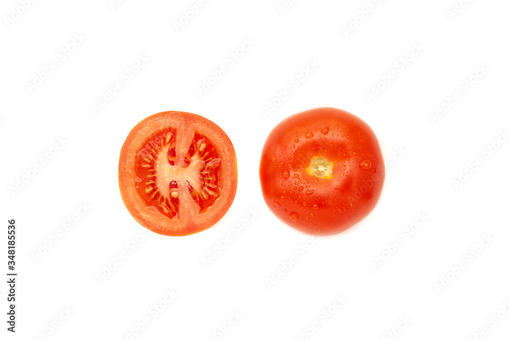 Whole tomato and tomato cut in half on a white background with water drops top view