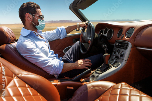 Handsome man in face mask in the car © ASjack
