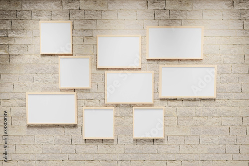 3D render illustration of multi size blank photo frames on the sand block bright wall. Empty picture frame mockup