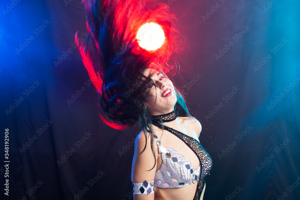 Portrait of a woman in oriental costume performing belly dance. Tribal fusion dance concept.
