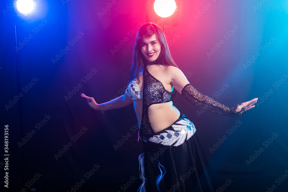 Fototapeta premium Spirituality dance. Beautiful sexy woman with luxury glossy eastern make-up dancing tribal fusion. Belly dance.