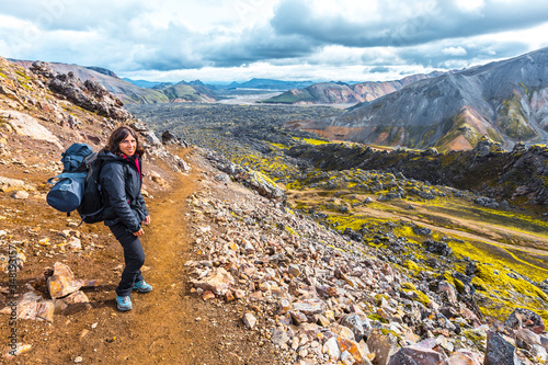 A young woman arriving at the volcanic ash valley from the 54 km trek from Landmannalaugar, Iceland