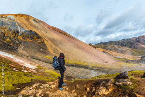 A young woman on the red mountain of the 54 km trek from Landmannalaugar, Iceland
