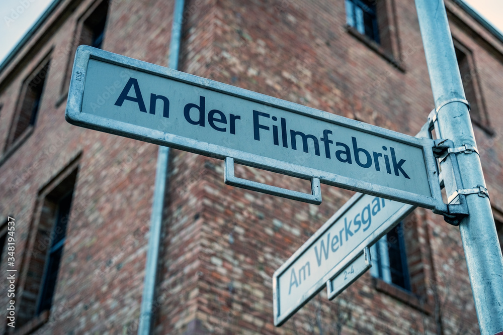 street sign in German Filmfabrik meaning Film Factory located in historical area still used to film movies and television shows street sign in German Filmfabrik meaning Film Factory located in historical area still used to film movies and television shows