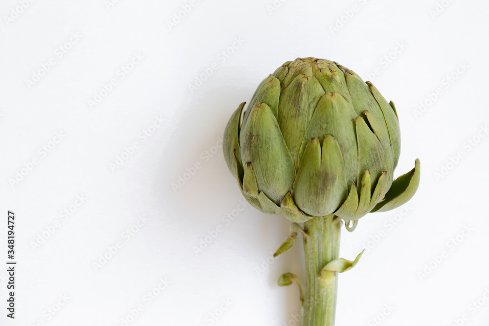Obraz premium Fresh green Italian Artichoke isolated on white background. Organic local produce vegetable on table top. Vegan diet. Clean eating concept. Close up, top view, flat lay.