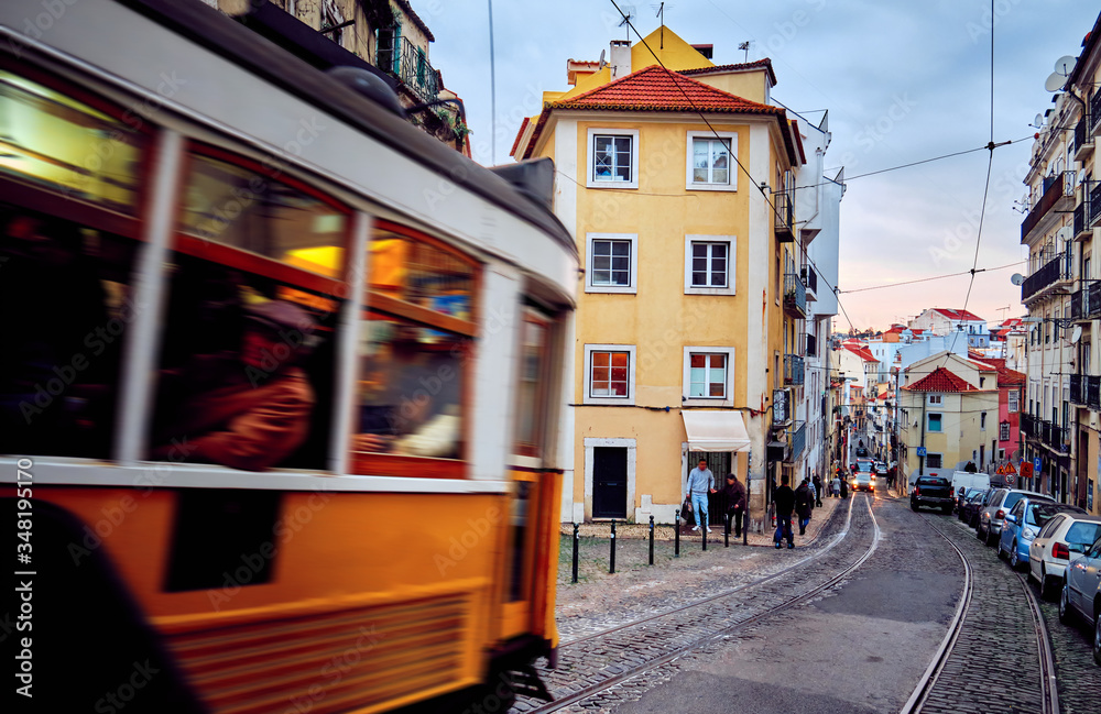 Obraz premium Old tram moves through the historic district in Lisbon.