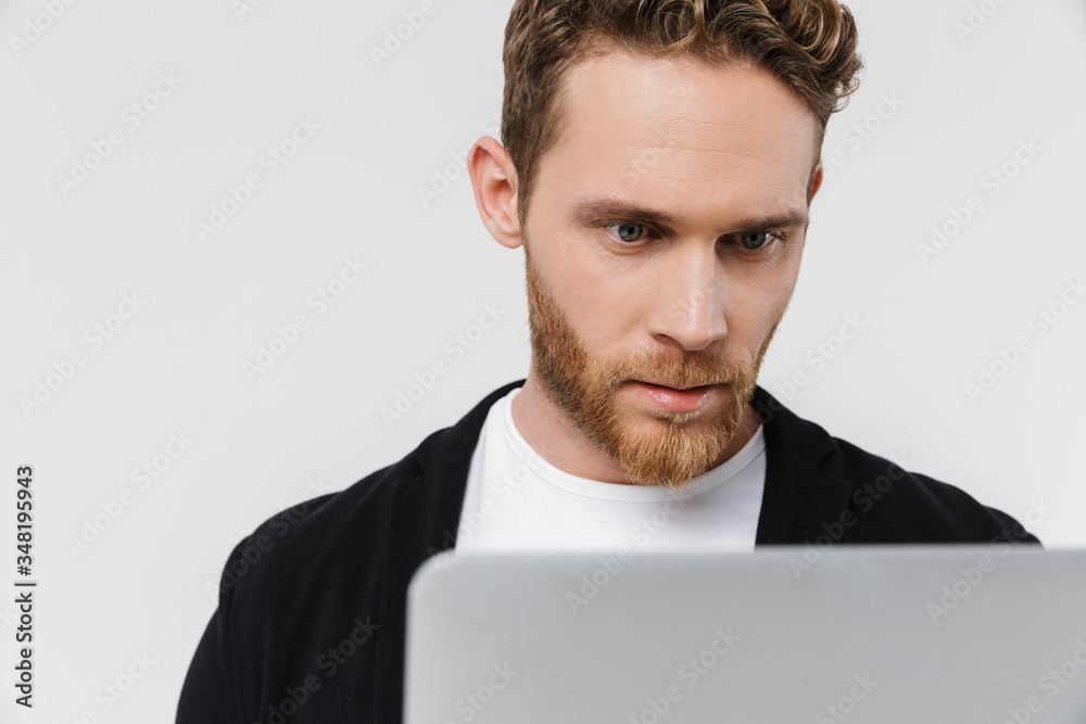 Image closeup of handsome focused man working with laptop Image closeup of handsome focused man working with laptop