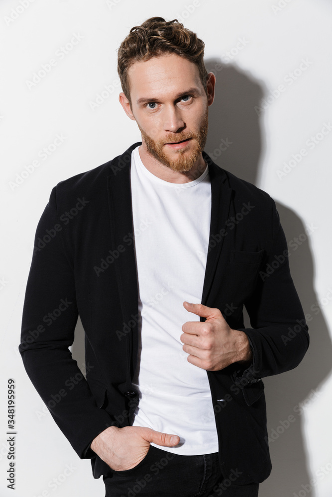 Image of unshaven confident man in jacket posing and looking at camera Image of unshaven confident man in jacket posing and looking at camera