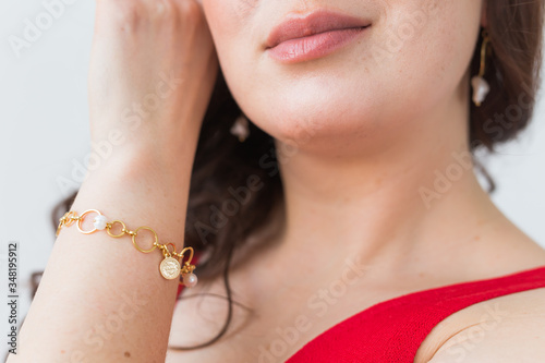 Close-up portrait of beautiful young woman with elegant hairstyle and luxurious jewelry and bijouterie.
