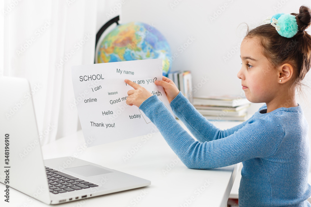English distance learning for kids. Homeschooling and distance learning for children. Girl student study online with video call teacher. English distance learning for kids. Homeschooling and distance learning for children. Girl student study online with video call teacher.