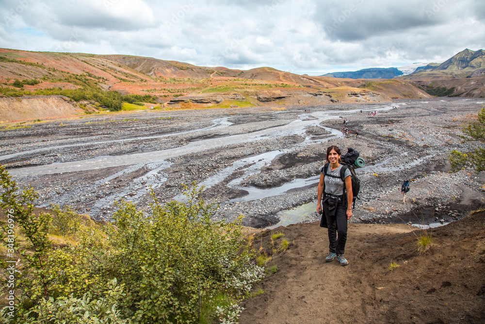 A young woman arriving at some cold rivers on the 4-day trek from Landmannalaugar. Iceland