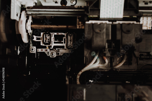 Close up interior of printer showing print heads in inkjet systems. Professional printer maintenance concept. Technical support in office hardware Continuous repair of the ink system. 
