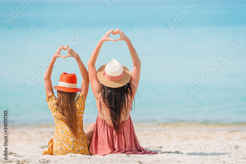 Beautiful mother and daughter on the beach