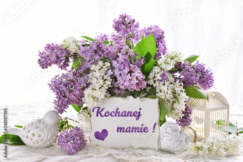 bunch of lilac blossoms for Mothers Day with inscription in Polish language translated as  For dear mom