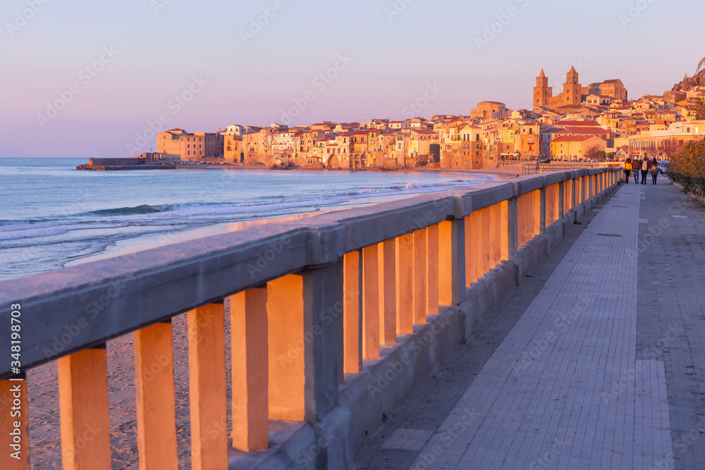 Beautiful view of the beach, Cefalu Cathedral and old town of coastal city Cefalu at sunset, Sicily, Italy