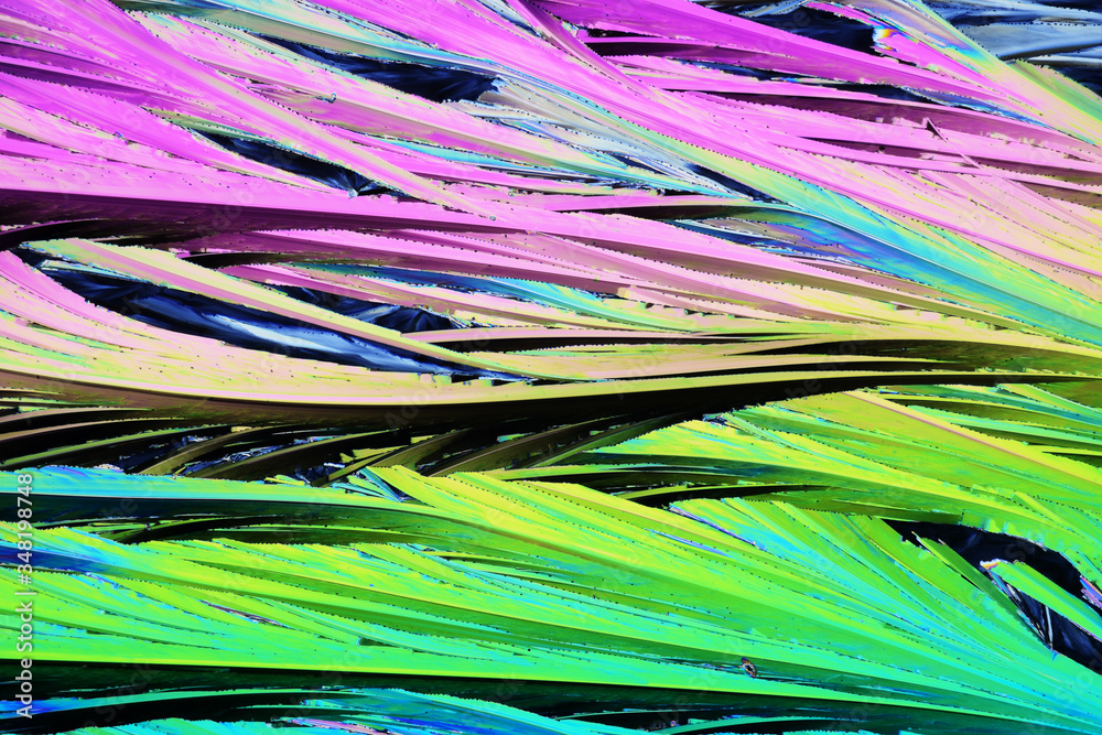 Colorful micro crystals in polarized light. Photo through a microscope. Colorful micro crystals in polarized light. Photo through a microscope.