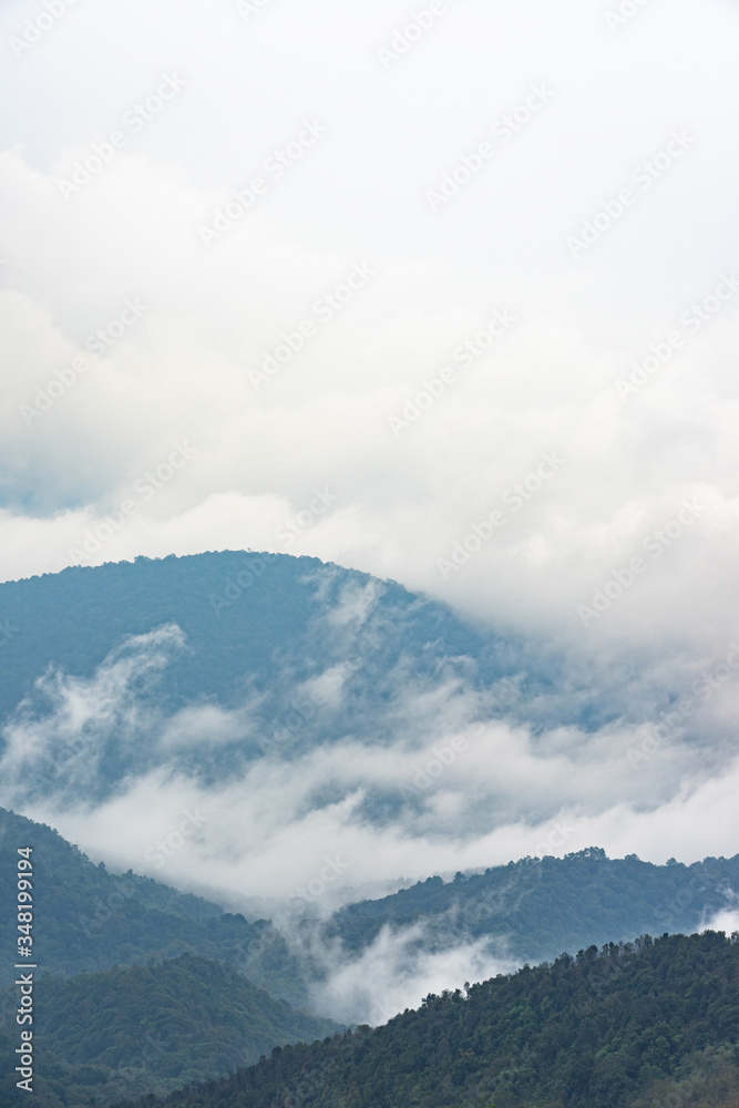 White clouds and mist over mountain range