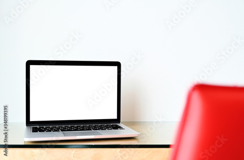 Laptop computer with blank screen in office
