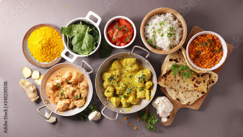 indian food meal in bowl with curry, chicken, naan and rice