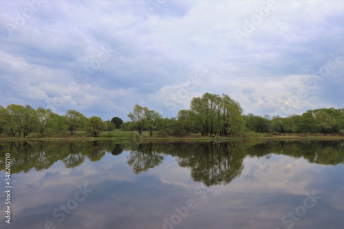 Beautiful river  trees  reflections in the homeland of Sergei Yesenin. Spring