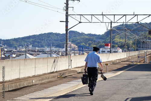 Japanese train conductor at station