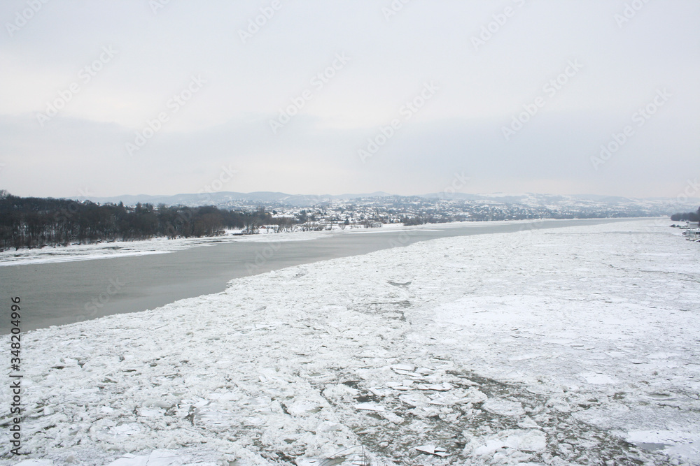 Broken ice in the frozen Danube river in Novi Sad,Serbia with Fruska gora in the back covered in snow.