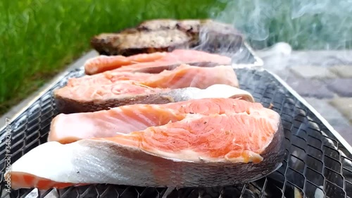 Steaming salmon steak on a grill