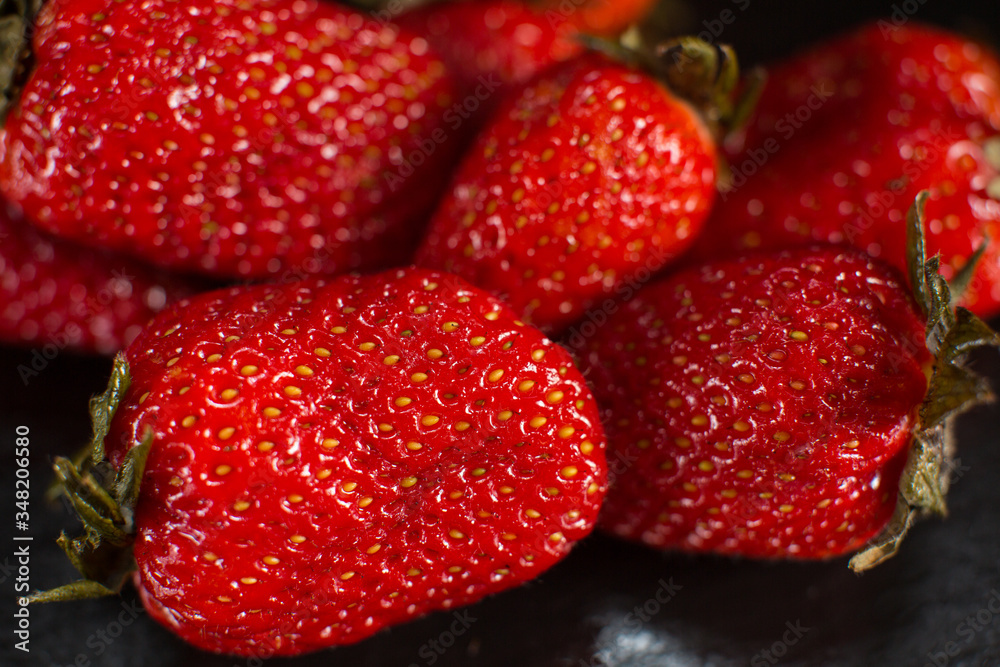 Directly above view of strawberry on black stone background. Directly above view of strawberry on black stone background.