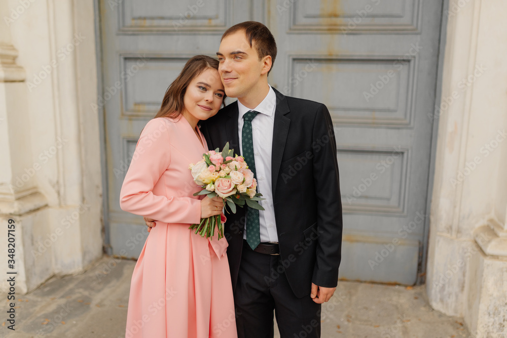Happy couple bride and groom near church door. beautiful wedding couple outdoors. Happy couple bride and groom near church door. beautiful wedding couple outdoors.