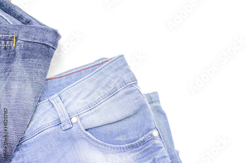 Blue jeans is on a white background. Clothes for donations. Fragments of clothing.