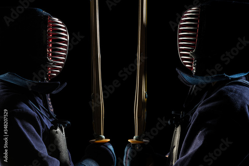 male in tradition kendo armor with shinai (bamboo sword). shot in studio. Isolated with clipping path on black background